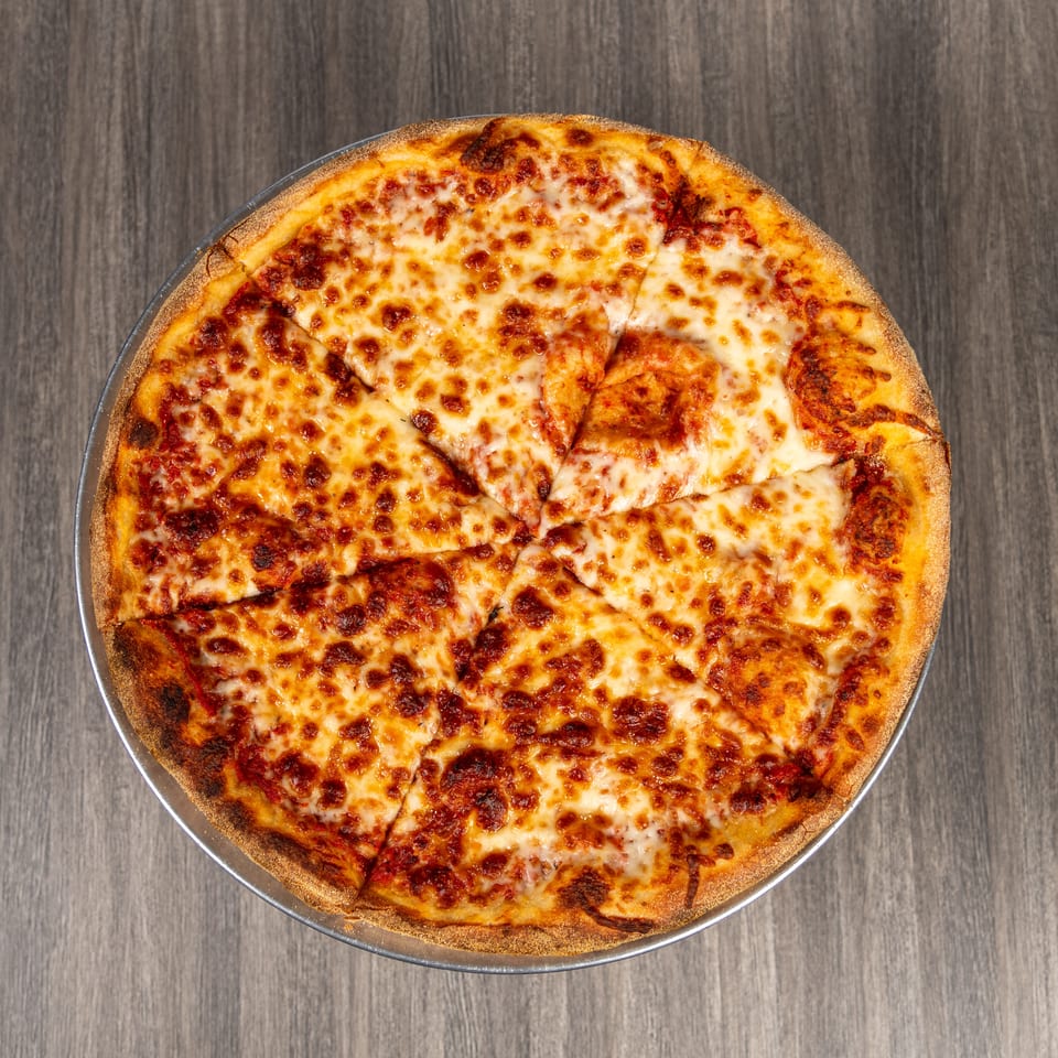 Overhead view of a sliced cheese pizza with tomato sauce and golden-brown crust on a metal pan.
